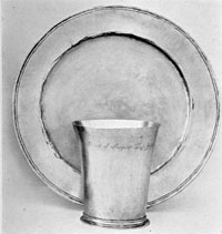 By Cesar Ghiselin: In their simplicity, this beaker and alms basin are typical of the 17th Century. Ghiselin was born in England, reached Philadelphia by 1693, and died in 1733, having worked for some years in Annapolis, Maryland. By Cesar Ghiselin: In their simplicity, this beaker and alms basin are typical of the 17th Century. Ghiselin was born in England, reached Philadelphia by 1693, and died in 1733, having worked for some years in Annapolis, Maryland.