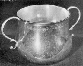 Illustration V: Caudle Cup by Quintard: Just under the rim is the inscription, "The Gift of Jonathan Gold to the Church of Christ in Stamford An Dom 1730." All that is known of the donor is that he was a sergeant in the militia, lived as a youth in New Haven and later removed to Stamford. About 1800, descendants changed the spelling their surname to Gould. This cup has long been used for baptisms. It is three and one-half inches high, four in diameter and has a spread of six and one-half inches across the handle.Illustration V: Caudle Cup by Quintard: Just under the rim is the inscription, "The Gift of Jonathan Gold to the Church of Christ in Stamford An Dom 1730." All that is known of the donor is that he was a sergeant in the militia, lived as a youth in New Haven and later removed to Stamford. About 1800, descendants changed the spelling their surname to Gould. This cup has long been used for baptisms. It is three and one-half inches high, four in diameter and has a spread of six and one-half inches across the handle. Illustration V: Caudle Cup by Quintard: Just under the rim is the inscription, "The Gift of Jonathan Gold to the Church of Christ in Stamford An Dom 1730." All that is known of the donor is that he was a sergeant in the militia, lived as a youth in New Haven and later removed to Stamford. About 1800, descendants changed the spelling their surname to Gould. This cup has long been used for baptisms. It is three and one-half inches high, four in diameter and has a spread of six and one-half inches across the handle.