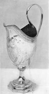 A Gilbert Cream Pitcher: The shaping of the base, in concaved octagonal form, is unusual. The touch-mark, Gilbert, in script, can be seen on the side of the base. A Gilbert Cream Pitcher: The shaping of the base, in concaved octagonal form, is unusual. The touch-mark, Gilbert, in script, can be seen on the side of the base.