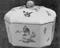 Illustration III: Derby Sugar Box: Hexagonal in form, with a shaped cover surmounted with a knob of modeled fruit. Typical of this factory's ware, the box is decorated with birds amid flowers. Illustration III: Derby Sugar Box: Hexagonal in form, with a shaped cover surmounted with a knob of modeled fruit. Typical of this factory's ware, the box is decorated with birds amid flowers.