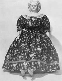 Illustration II: Doll with Composition Head: Made by Ludwig Greiner who produced these dolls from 1858 to 1878. This example with full skirted flowered dress portrays the styles of the mid-19th Century. Illustration II: Doll with Composition Head: Made by Ludwig Greiner who produced these dolls from 1858 to 1878. This example with full skirted flowered dress portrays the styles of the mid-19th Century.