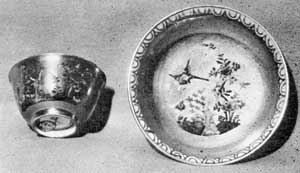 Illustration VII: Dresden Cup and Saucer: Made circa 1725 and bearing the crossed-swords mark, the decoration is the earliest of underglaze cobalt blue. The gilding is overglaze and fired. The cup is three inches in diameter and the saucer five. Illustration VII: Dresden Cup and Saucer: Made circa 1725 and bearing the crossed-swords mark, the decoration is the earliest of underglaze cobalt blue. The gilding is overglaze and fired. The cup is three inches in diameter and the saucer five.