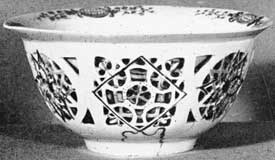 Illustration I: Earliest White Dresden Porcelain: This bowl, six inches in diameter and unmarked, was made circa 1712. It was copied from a Chinese model with double sides. The outer one was worked a jour. Decorated with lacquer painting in four colors. Illustration I: Earliest White Dresden Porcelain: This bowl, six inches in diameter and unmarked, was made circa 1712. It was copied from a Chinese model with double sides. The outer one was worked a jour. Decorated with lacquer painting in four colors.