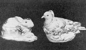 Illustration I: Examples from Derby and Chelsea: These two table accessories were used as either a sauce tureen or a sugar box. Both are decorated in natural colors. They are splendid examples of the use of the rabbit and the dove in ceramic decoration. Illustration I: Examples from Derby and Chelsea: These two table accessories were used as either a sauce tureen or a sugar box. Both are decorated in natural colors. They are splendid examples of the use of the rabbit and the dove in ceramic decoration.