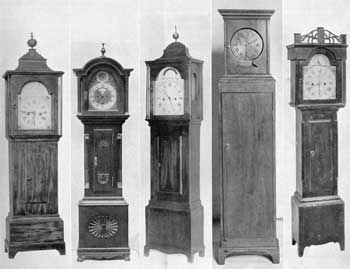 Five Characteristic American Grandmother Clocks: From left to right the makers and height are Reuben Tower, Hingham, Mass., 46 inches; Valin, Quebec, 48 inches; Joshua Wilder, Hingham, Mass., 46 inches; probably by Simon Willard, Roxbury, Mass., 46 inches; and Levi Hutchins, Concord, N. H., 45 inches. Five Characteristic American Grandmother Clocks: From left to right the makers and height are Reuben Tower, Hingham, Mass., 46 inches; Valin, Quebec, 48 inches; Joshua Wilder, Hingham, Mass., 46 inches; probably by Simon Willard, Roxbury, Mass., 46 inches; and Levi Hutchins, Concord, N. H., 45 inches.