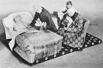 A Folk Art Washington Memorial: Here, the dolls are all made of cloth with finely stitched leather hands and feet. It was made early in the 19th Century — probably in Pennsylvania, where it was recently found. The group shows General Washington in bed, Dr. James Craik standing beside him, Mrs. Washington sitting in a wing chair, and Christopher, the general's personal servant, behind her with bottle and glass in hand. A Folk Art Washington Memorial: Here, the dolls are all made of cloth with finely stitched leather hands and feet. It was made early in the 19th Century — probably in Pennsylvania, where it was recently found. The group shows General Washington in bed, Dr. James Craik standing beside him, Mrs. Washington sitting in a wing chair, and Christopher, the general's personal servant, behind her with bottle and glass in hand.
