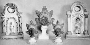 Further Rarities in Pennsylvania Chalk: Two brilliantly colored watch holders. Both are reminiscent of 18th-Century household shrines. That at the left is cruder in modeling and painting. In its niche stands a typical bird. The one at the right has welt-executed classical columns complete with bases and capitals and connected by a Romanesque arch. In the center sits a small boy unconsciously replacing a youthful saint or Christ child. Painted decorations at the sides and above follow the shrine original closely. In the center, garnitures with conventionalized reproductions of the mock orange in yellow ochre with mellow green foliage front and back. Further Rarities in Pennsylvania Chalk: Two brilliantly colored watch holders. Both are reminiscent of 18th-Century household shrines. That at the left is cruder in modeling and painting. In its niche stands a typical bird. The one at the right has welt-executed classical columns complete with bases and capitals and connected by a Romanesque arch. In the center sits a small boy unconsciously replacing a youthful saint or Christ child. Painted decorations at the sides and above follow the shrine original closely. In the center, garnitures with conventionalized reproductions of the mock orange in yellow ochre with mellow green foliage front and back.