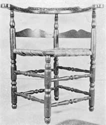 Illustration II: A well-proportioned country chair, with original Cape Cod brown paint, circa 1780-1800. Made of maple with hickory back-slats. The turnings of legs and all eight stretchers are vigorous. The Cupid's bow outline of upper edge of back-slat differs from that of ladder-back chairs of the period. Illustration II: A well-proportioned country chair, with original Cape Cod brown paint, circa 1780-1800. Made of maple with hickory back-slats. The turnings of legs and all eight stretchers are vigorous. The Cupid's bow outline of upper edge of back-slat differs from that of ladder-back chairs of the period.