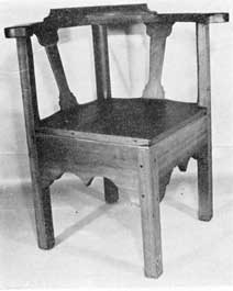 Illustration VII: Somewhat Gothic in outline, this commode chair of cherry dates between 1760 and 1800. The seat is removable, disclosing the construction for the commode which is hidden by the deep skirts of the front. Illustration VII: Somewhat Gothic in outline, this commode chair of cherry dates between 1760 and 1800. The seat is removable, disclosing the construction for the commode which is hidden by the deep skirts of the front.