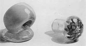 ILLUSTRATION IV: An Apple Paperweight by Lutz: The other at the right may have been designed for use as a doorknob or large bottle stopper. ILLUSTRATION IV: An Apple Paperweight by Lutz: The other at the right may have been designed for use as a doorknob or large bottle stopper.