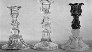 Loop-and-Petal and Baluster Candlesticks: Left to right, a loop-and-petal base and baluster top; center, loop-and-petal top, baluster base; right, all loop-and-petal with milk white base and blue top. The latter has original gold leaf decoration. Loop-and-Petal and Baluster Candlesticks: Left to right, a loop-and-petal base and baluster top; center, loop-and-petal top, baluster base; right, all loop-and-petal with milk white base and blue top. The latter has original gold leaf decoration.