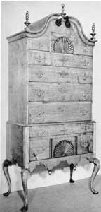 New England Maple Highboy: With bonnet top, fan-carved drawer fronts, finials and scalloped apron, this is a typical example of the design during the latter part of the period. New England Maple Highboy: With bonnet top, fan-carved drawer fronts, finials and scalloped apron, this is a typical example of the design during the latter part of the period.