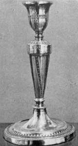 Silver owned by Irving: One of a pair of plated Sheffield candlesticks, c. 18oo, in the spirit of the brothers Adam. Silver owned by Irving: One of a pair of plated Sheffield candlesticks, c. 18oo, in the spirit of the brothers Adam.