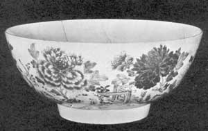 Oriental Lowestoft Punch Bowl, 1750-1760: An example of the second period, this piece originally belonged to Governor Benning Wentworth of New Hampshire. A fine piece of porcelain with a bluish tint to the glaze. The decoration is more extensive than later. The Two Periods Compared: At the left, a cream pitcher, 6 inches tall, brought from England in 1767. The flowers are very clear pink and purple, the deeper border is pink, and the whole decoration picked out with gold. The mug at the right, 5 inches tall, is in blue and gold and bears the cipher SD. It dates about 1802.