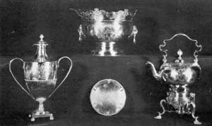 Other English Silver: Top row: Monteith by Fras Spilsburg, London, 1733, with Garlick arms and crest. Bottom row: Two-handled cup, John Carter, London, 1774, with Custis crest and formerly at Mount Vernon; tea kettle on-stand, William Grundy, London, 1749, inherited from Zinne Carter of Cleve. Other English Silver: Top row: Monteith by Fras Spilsburg, London, 1733, with Garlick arms and crest. Bottom row: Two-handled cup, John Carter, London, 1774, with Custis crest and formerly at Mount Vernon; tea kettle on-stand, William Grundy, London, 1749, inherited from Zinne Carter of Cleve.