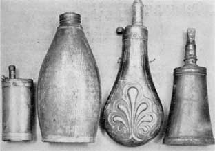 Plate I – Four Distinct Types: Left to right, there are brass combination container with compartments for powder, percussion caps, bullets, and bird shot; tin flask with screw-top, probably used as shipping container; an English flask of zinc; and a transitional flask with metal ends set into a section of cow's horn. Plate I – Four Distinct Types: Left to right, there are brass combination container with compartments for powder, percussion caps, bullets, and bird shot; tin flask with screw-top, probably used as shipping container; an English flask of zinc; and a transitional flask with metal ends set into a section of cow's horn.