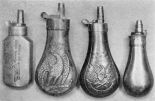 Plate II – Four American Flasks: Right to left they are marked "Robbins and Lawrence Co., Patent Revolving Hammer Pistol, Windsor, Vt."; "Colt's Patent" used with 44 so universally popular with western adventurers; an army officer's flask hearing the motto, "E Pluribus Unum"; and a smaller unmarked pistol flask with graduation to regulate the amount of the charge of powder. Plate II – Four American Flasks: Right to left they are marked "Robbins and Lawrence Co., Patent Revolving Hammer Pistol, Windsor, Vt."; "Colt's Patent" used with 44 so universally popular with western adventurers; an army officer's flask hearing the motto, "E Pluribus Unum"; and a smaller unmarked pistol flask with graduation to regulate the amount of the charge of powder.