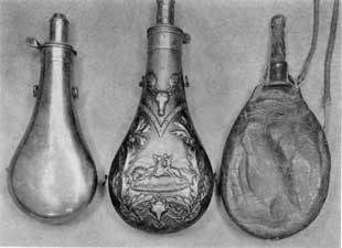 Plate IV – Three Contrasting Types: Left, the earliest type, no decoration or maker's mark; center, a sportsman's flask with central scene showing an Indian buffalo hunting; right a homemade shot pouch of leather with horn nipple and cap. Shot carried in a metal flask might rattle and warn the game being hunted. Plate IV – Three Contrasting Types: Left, the earliest type, no decoration or maker's mark; center, a sportsman's flask with central scene showing an Indian buffalo hunting; right a homemade shot pouch of leather with horn nipple and cap. Shot carried in a metal flask might rattle and warn the game being hunted.