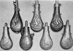 Plate V – Seven Typical Flasks: Top row, three with same embossed decoration of hanging game. At the left, a leather flask for bird shot; center, copper flask marked "James Dixon & Sons" immediately beneath the decoration; right, a copy of the same design marked on the charger, "American Flask & Cap Company." Bottom row; left to right, an unmarked American army flask; an English flask with Grecian decoration; and two English sporting flasks with hunting scenes in which the men wear top hats. Plate V – Seven Typical Flasks: Top row, three with same embossed decoration of hanging game. At the left, a leather flask for bird shot; center, copper flask marked "James Dixon & Sons" immediately beneath the decoration; right, a copy of the same design marked on the charger, "American Flask & Cap Company." Bottom row; left to right, an unmarked American army flask; an English flask with Grecian decoration; and two English sporting flasks with hunting scenes in which the men wear top hats.