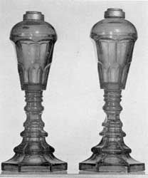 Sandwich Glass Lamps: Of cobalt-blue pressed glass, these originally had burners with double-wick tubes that screwed into the metal collar at the top of the font. They were used first for whale oil and later for the more improved types of illuminants Sandwich Glass Lamps: Of cobalt-blue pressed glass, these originally had burners with double-wick tubes that screwed into the metal collar at the top of the font. They were used first for whale oil and later for the more improved types of illuminants