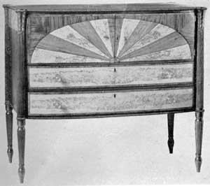 Illustration III: Sideboard by William Hook: The piece, with door fronts inlaid in an unusual half-oval pattern, was made as a wedding present, 1808-09, for his sister Hannah Hook Folsom. The reeded legs, with waterleaf capitals, are characteristic of Salem work. Illustration III: Sideboard by William Hook: The piece, with door fronts inlaid in an unusual half-oval pattern, was made as a wedding present, 1808-09, for his sister Hannah Hook Folsom. The reeded legs, with waterleaf capitals, are characteristic of Salem work.