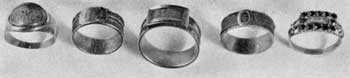 Styles in Gold Mourning Rings: Left to right, they bear dated inscriptions for E. F. Cortlandt, 1786; Cornelia Clinton, 1791; Volkert Petrus Douw, 1800; John Waddell Taylor, 1801; and Mary Ten Eyck, 1818. The latter ring is set with twelve gem-cut pieces of jet. Styles in Gold Mourning Rings: Left to right, they bear dated inscriptions for E. F. Cortlandt, 1786; Cornelia Clinton, 1791; Volkert Petrus Douw, 1800; John Waddell Taylor, 1801; and Mary Ten Eyck, 1818. The latter ring is set with twelve gem-cut pieces of jet.