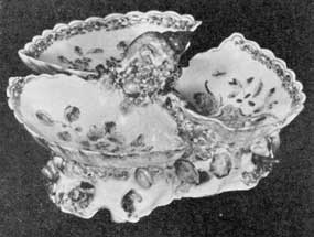 Illustration II: Sweetmeat Dish: This example, made at the Bow factory about 1755, has a simple Chinese floral decoration. The modeling of the three compartments are somewhat shell-like in feeling. Illustration II: Sweetmeat Dish: This example, made at the Bow factory about 1755, has a simple Chinese floral decoration. The modeling of the three compartments are somewhat shell-like in feeling.