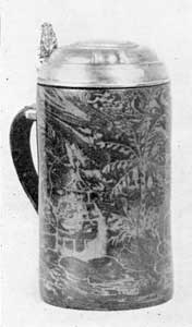 Illustration II: Tankard of Boettger: Porcelain: This unique piece, formerly in the Hearst collection, was made circa 1710. It has silver gilt mounting and is unmarked. It was copied from a tin model. The decoration was produced by incrusting of lighter shade on a darker background. It is eight inches tall. Illustration II: Tankard of Boettger: Porcelain: This unique piece, formerly in the Hearst collection, was made circa 1710. It has silver gilt mounting and is unmarked. It was copied from a tin model. The decoration was produced by incrusting of lighter shade on a darker background. It is eight inches tall.