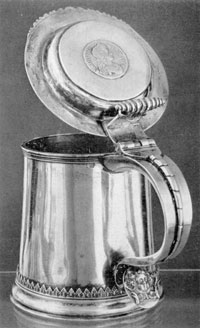 Illustration I: Tankard by Quintard and LeRoux: As both were Huguenots, it is probable that Quintard served his apprenticeship under LeRoux, who was ten years his elder. The decorative detail of this tankard, in the acanthus leaf above the base molding and wing head on the spur of the handle, is characteristic of LeRoux work. The coin set in the center of the lid is English, bearing the profile and inscription of Charles II. Illustration I: Tankard by Quintard and LeRoux: As both were Huguenots, it is probable that Quintard served his apprenticeship under LeRoux, who was ten years his elder. The decorative detail of this tankard, in the acanthus leaf above the base molding and wing head on the spur of the handle, is characteristic of LeRoux work. The coin set in the center of the lid is English, bearing the profile and inscription of Charles II.