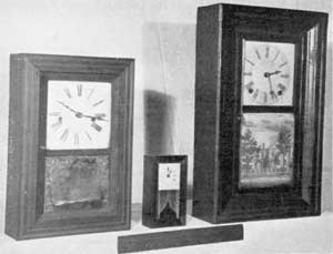 Three Variations in Size: Left to right, a miniature by Manross; center, a very small example made quite late by the New Haven Clock Co.; and right, a small size of the standard clock in ogee case made by J. C. Brown. Three Variations in Size: Left to right, a miniature by Manross; center, a very small example made quite late by the New Haven Clock Co.; and right, a small size of the standard clock in ogee case made by J. C. Brown.