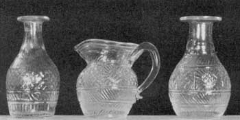 Illustration VI: Toy Decanters and Cream Pitcher: These decanters, at most, hold one-quarter pint. The cream pitcher and the decanter at the right are of the same pattern and could have been made from the same mold. Illustration VI: Toy Decanters and Cream Pitcher: These decanters, at most, hold one-quarter pint. The cream pitcher and the decanter at the right are of the same pattern and could have been made from the same mold.