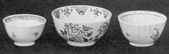 Two Cups and a Small Bowl: The bowl with more extensive decoration and in clear colors dates from 1767. The cup at the left, decorated all in a dull pink, is about 1815; that at the right, done in various colors with a pink border, is more brilliant than the other cup. Notice the sparcity of design on the cups compared with the earlier bowl. Two Cups and a Small Bowl: The bowl with more extensive decoration and in clear colors dates from 1767. The cup at the left, decorated all in a dull pink, is about 1815; that at the right, done in various colors with a pink border, is more brilliant than the other cup. Notice the sparcity of design on the cups compared with the earlier bowl.
