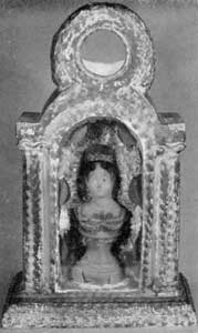 Watch Holder in Chalk: With niche and flanking columns, this design follows earlier European religious shrines. The circular opening at the top would show the face of a large watch. The portrait bust in the niche behind glass is known as that of Mrs. Jackson. The niche is lined with silver paper painted with flowers. Watch Holder in Chalk: With niche and flanking columns, this design follows earlier European religious shrines. The circular opening at the top would show the face of a large watch. The portrait bust in the niche behind glass is known as that of Mrs. Jackson. The niche is lined with silver paper painted with flowers.