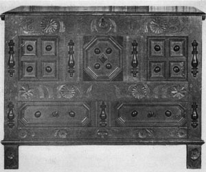 A 17th Century Dower Chest: An outstanding piece typical of those of Hartford origin this was an early example of the blanket chest that continued to be made in America through the first quarter of the 19th Century. Beneath the chest part it has two parallel drawers. Made of paneled oak, decoration of the front was achieved by shallow carving and half-round applied turnings painted black. 17centdowerchest