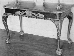 An American Serving Table: Made of mahogany, with unusual gilded carving, this table with dark marble top was made in New York about 1750. The feet have the rare five claws — most have only four. Its original owner was General John Mansell, whose residence was at 12 Broadway. An American Serving Table: Made of mahogany, with unusual gilded carving, this table with dark marble top was made in New York about 1750. The feet have the rare five claws — most have only four. Its original owner was General John Mansell, whose residence was at 12 Broadway.
