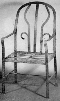 An Armchair in Iron: In design, this is probably a Chippendale-Hepplewhite transition piece. The front of the legs and back are nicely reeded and it has small, simple paw feet. An Armchair in Iron: In design, this is probably a Chippendale-Hepplewhite transition piece. The front of the legs and back are nicely reeded and it has small, simple paw feet.