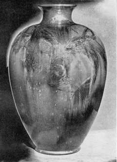 Illustration VI: A Tiger Eye Vase: The work of John Daly, it was made at Rookwood circa 1888. The crystalline "tiger eye" glaze was first produced at the pottery in 1884 and was revived in new and more varied colors to celebrate the fortieth anniversary of Rookwood. This piece is the most outstanding example of the use of this glaze ever made at the pottery. Illustration VI: A Tiger Eye Vase: The work of John Daly, it was made at Rookwood circa 1888. The crystalline "tiger eye" glaze was first produced at the pottery in 1884 and was revived in new and more varied colors to celebrate the fortieth anniversary of Rookwood. This piece is the most outstanding example of the use of this glaze ever made at the pottery.