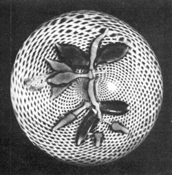 A Baccarat Fuchsia: Here the design of blooms, buds, leaves, and supporting stem rests on latticinio interlacing white threads of circular pattern. A Baccarat Fuchsia: Here the design of blooms, buds, leaves, and supporting stem rests on latticinio interlacing white threads of circular pattern.