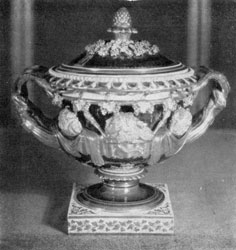 Large Chamberlain Worcester Covered Urn: Done in bleu-du-roi as the color of the background, it has a highly embossed design of figures, grapevines, and twig handles finished in flat burnished gold. Large Chamberlain Worcester Covered Urn: Done in bleu-du-roi as the color of the background, it has a highly embossed design of figures, grapevines, and twig handles finished in flat burnished gold.