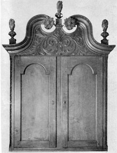 Detail of Two Bachman Secretaries: Notice the differences in motif of the carved ornamentation on the bonnet tops, and variation in shaping and placement of the flame finials. The secretary at the left was made circa 1780-1800; that at the right circa 1766-1770. Detail of Two Bachman Secretaries: Notice the differences in motif of the carved ornamentation on the bonnet tops, and variation in shaping and placement of the flame finials. The secretary at the left was made circa 1780-1800; that at the right circa 1766-1770.