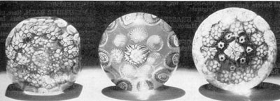 Three Millefiori Glass Doorknobs: That at the left has been faceted on a cutting wheel to make it more nearly square. The one in the center and that at the right are typical of the millefiori paperweights made at American factories — probably Sandwich. All have shanks at the base so that they could be mounted in brass for use as decorative hardware. Three Millefiori Glass Doorknobs: That at the left has been faceted on a cutting wheel to make it more nearly square. The one in the center and that at the right are typical of the millefiori paperweights made at American factories — probably Sandwich. All have shanks at the base so that they could be mounted in brass for use as decorative hardware.