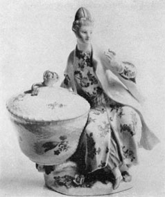 An Early Meissen Piece: The design is of a woman seated beside a covered basket. The decoration is in the Chinese manner. It was made circa 1745. An Early Meissen Piece: The design is of a woman seated beside a covered basket. The decoration is in the Chinese manner. It was made circa 1745.