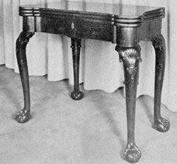 Georgian Gaming Table: Made of mahogany, circa 1740, it has four cabriole legs terminating in boldly carved ball-and-claw feet. The triple top, when opened, shows a backgammon board, places for candles, and wells for dice and gambling counters. Georgian Gaming Table: Made of mahogany, circa 1740, it has four cabriole legs terminating in boldly carved ball-and-claw feet. The triple top, when opened, shows a backgammon board, places for candles, and wells for dice and gambling counters.