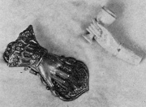 Hand Motif in Useful Objects: Upper right, bone pipe with hand holding the bowl; lower left, a brass paper clip. Hand Motif in Useful Objects: Upper right, bone pipe with hand holding the bowl; lower left, a brass paper clip.