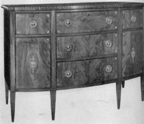 A Hepplewhite Butler's Side Board: An example of Salem, Massachusetts, cabinetmaking. It was made about 1800-1810. The top drawer is fitted as a desk. When pulled out, the front folds down to make it practical for writing. It was made of crotch grain mahogany veneer with decorative inlays of wood of contrasting colors. A Hepplewhite Butler's Side Board: An example of Salem, Massachusetts, cabinetmaking. It was made about 1800-1810. The top drawer is fitted as a desk. When pulled out, the front folds down to make it practical for writing. It was made of crotch grain mahogany veneer with decorative inlays of wood of contrasting colors.