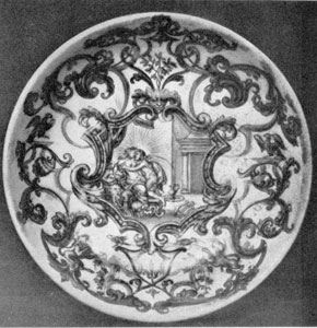Illustration VI: B. F. Bottengruber, Breslau, C. 1730: The decoration is a central mythological scene surrounded by elaborate scroll work done in gold which completely covers this saucer. Illustration VI: B. F. Bottengruber, Breslau, C. 1730: The decoration is a central mythological scene surrounded by elaborate scroll work done in gold which completely covers this saucer.