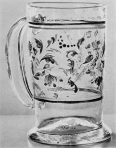 A Stiegel-Type Mug: Of clear glass, it is decorated with enamel in various colors, done in a leaf design, with bands top and bottom. A Stiegel-Type Mug: Of clear glass, it is decorated with enamel in various colors, done in a leaf design, with bands top and bottom.