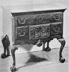 A Philadelphia Lowboy: Made in walnut, the ornamentation, proportions, and workmanship of this piece is representative of the best Philadelphia craftsmanship. The carved leafage on the cabriole legs and the concaved shell and volutes of the central small drawer are particularly well executed. It was made for a member of the Franklin family. A Philadelphia Lowboy: Made in walnut, the ornamentation, proportions, and workmanship of this piece is representative of the best Philadelphia craftsmanship. The carved leafage on the cabriole legs and the concaved shell and volutes of the central small drawer are particularly well executed. It was made for a member of the Franklin family.