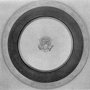 Service Plate from Wilson Service: The borders are of etched gold and the rim of cobalt blue. The President's seal in the center is of raised paste and gold. Service Plate from Wilson Service: The borders are of etched gold and the rim of cobalt blue. The President's seal in the center is of raised paste and gold.