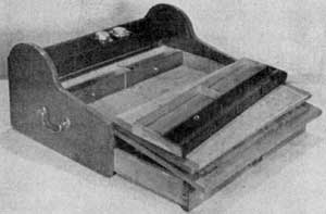 Tambour Desk in Light Mahogany: Also of the size for use by a man being 18 by 12 1/4 by 8 1/4 inches. It is shown open to illustrate a common arrangement of secret compartments in desk of this type. Tambour Desk in Light Mahogany: Also of the size for use by a man being 18 by 12 1/4 by 8 1/4 inches. It is shown open to illustrate a common arrangement of secret compartments in desk of this type.